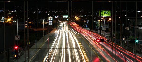 Light trails of cars on road at night