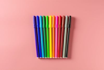 Directly above of colorful felt tip pens on colored background