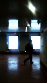 Rear view of woman walking in corridor