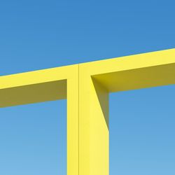 Yellow shape building with shadows on sky background. minimal architecture ideas concept. 3d render.
