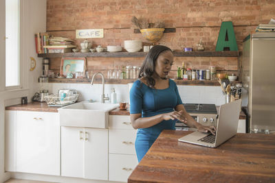 Businesswoman working on her laptop from home