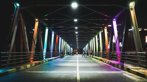 Illuminated bridge at night