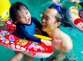 Father and daughter in swimming pool