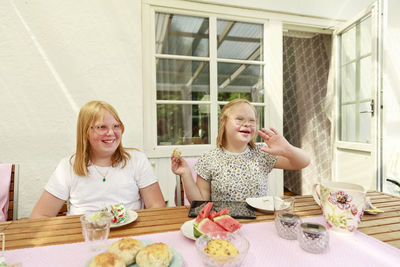 Girls sitting at table and eating