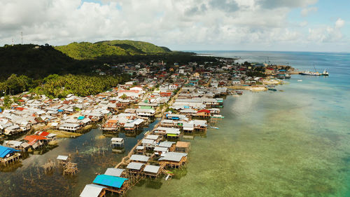 Fishing village of stilt houses built over the sea, top view. dapa, siargao, philippines.