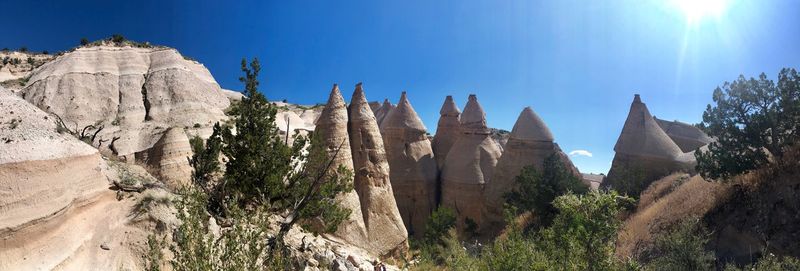 Low angle view of rocks against blue sky