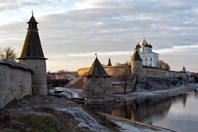 Trinity cathedral by velikaya river against sky