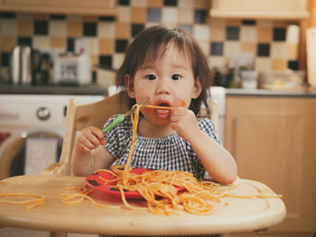 Portrait of girl eating pasta