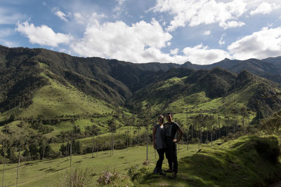 Portrait of couple standing at cocora valley against sky