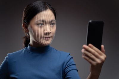 Portrait of man holding mobile phone