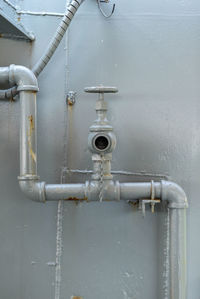 Close-up of pipes against wall