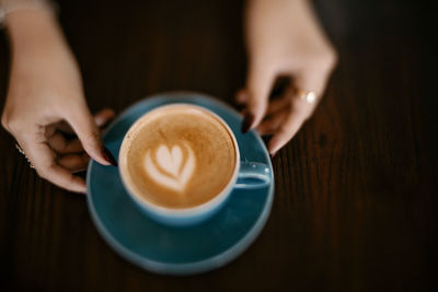 Midsection of coffee cup on table