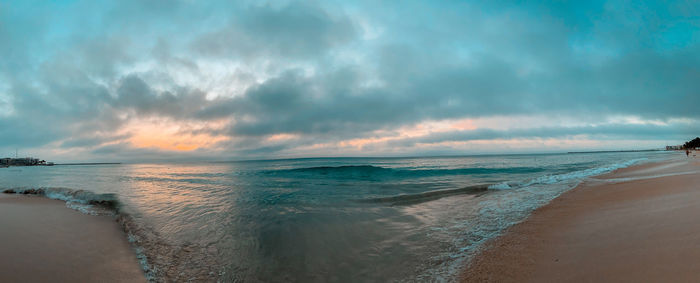 Scenic view of beach against sky during sunset