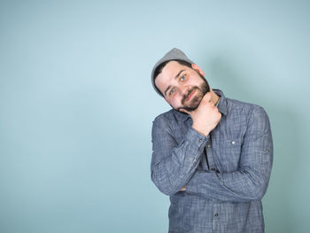 Portrait of man standing against white background