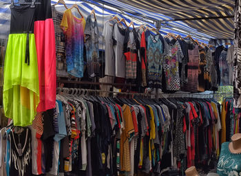 Various flags hanging in store for sale at market stall