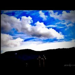 Scenic view of mountains against cloudy sky