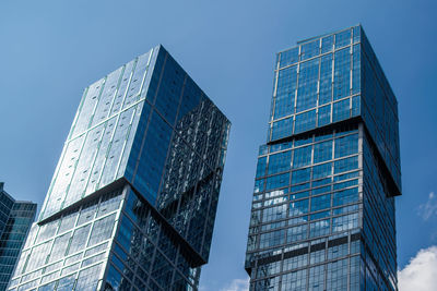 Low angle view of skyscrapers against clear blue sky