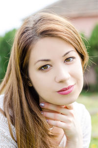 Close-up portrait of smiling young woman