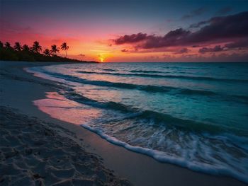 Scenic view of beach against sky during sunset