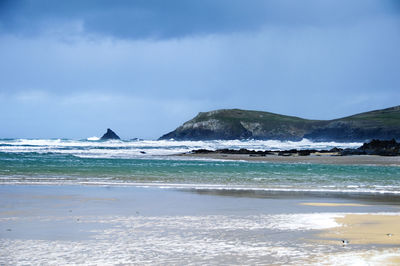 Scenic view of sea against cloudy sky