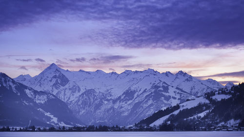 Scenic view of snowcapped mountains against sky during sunset