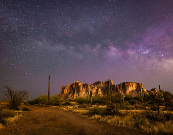 Scenic view of rock formation against sky at night