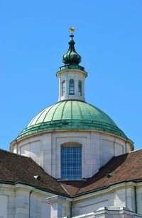 Low angle view of solothurn cathedral against clear blue sky