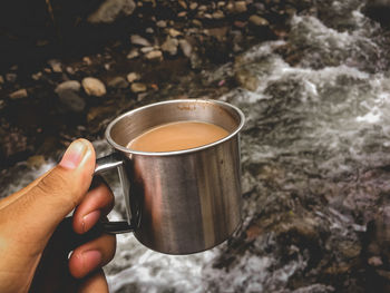 Hand holding coffee cup