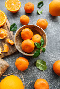 Fresh citrus fruits tangerines, oranges on a concrete background