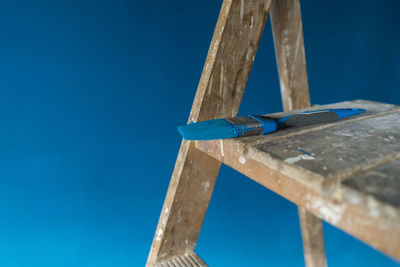 Low angle view of metallic structure against blue sky