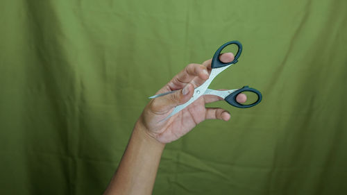 Cropped hand of doctor holding thermometer