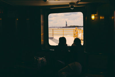 People sitting in boat by window