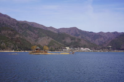 Scenic view of sea and mountains against sky