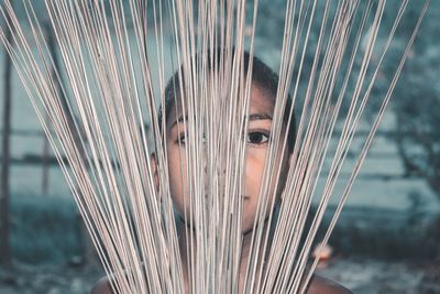 Close-up portrait of boy with broom