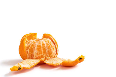 Close-up of orange slice against white background