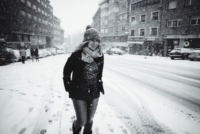 Woman standing on road in city