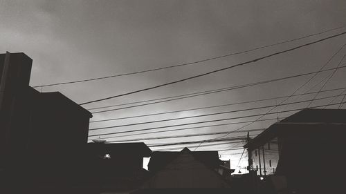 Low angle view of silhouette buildings against sky