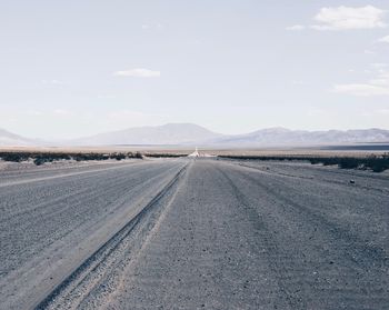 Road by landscape against sky