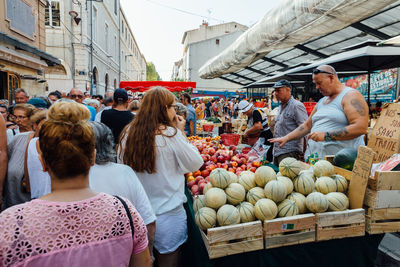 Group of people at market stall in city