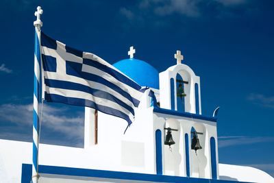 Geek flag in front of church in fira - santorini, greece 2022