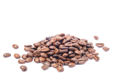 Close-up of coffee beans against white background