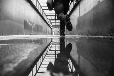 Low section of man walking by canal