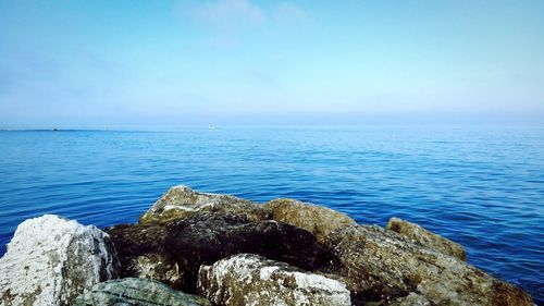 Scenic view of sea against blue sky