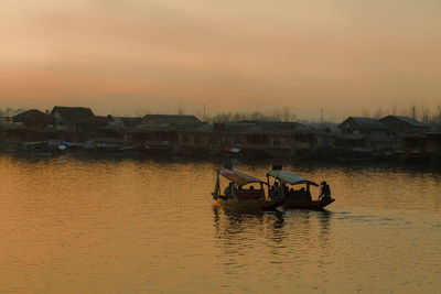 Boat sailing in sea at sunset