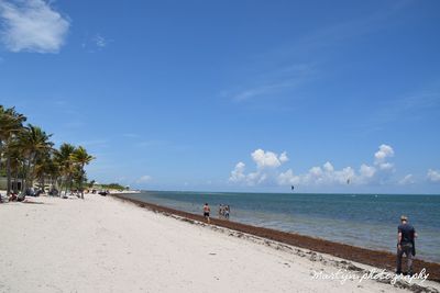 People on beach against sky