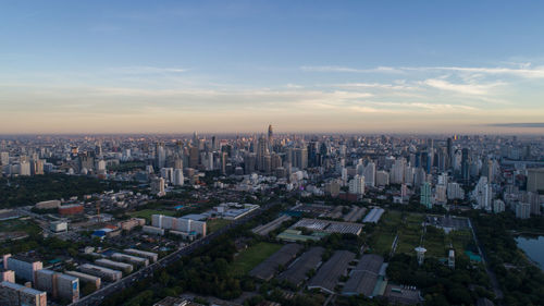 Aerial view of buildings in city against sky