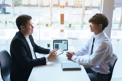 Young man using mobile phone in office