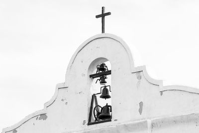 Low angle view of cross against clear sky