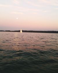 View of boat in sea at sunset