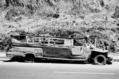 Vintage car on road against trees